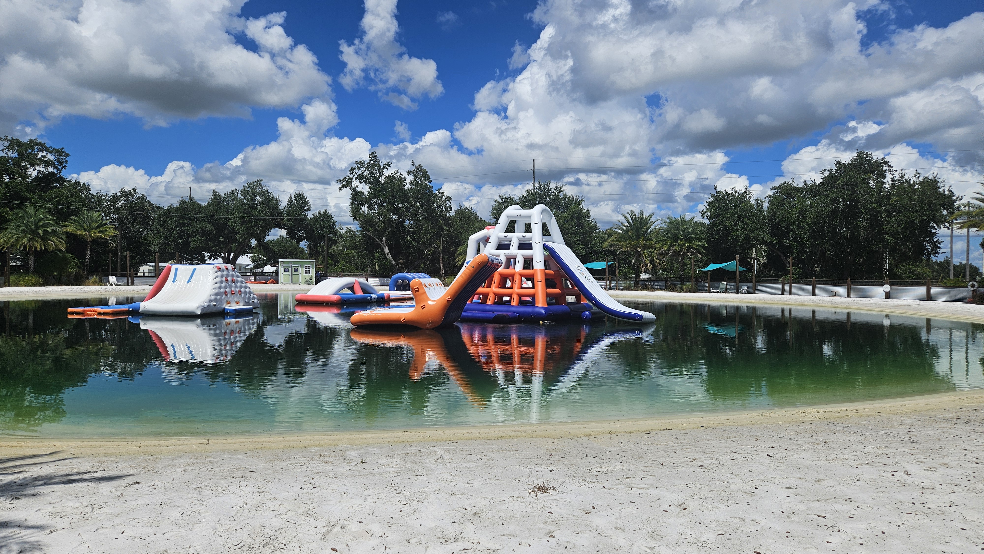 Aqua water park inflatable slides at Camp Impact under sunny sky